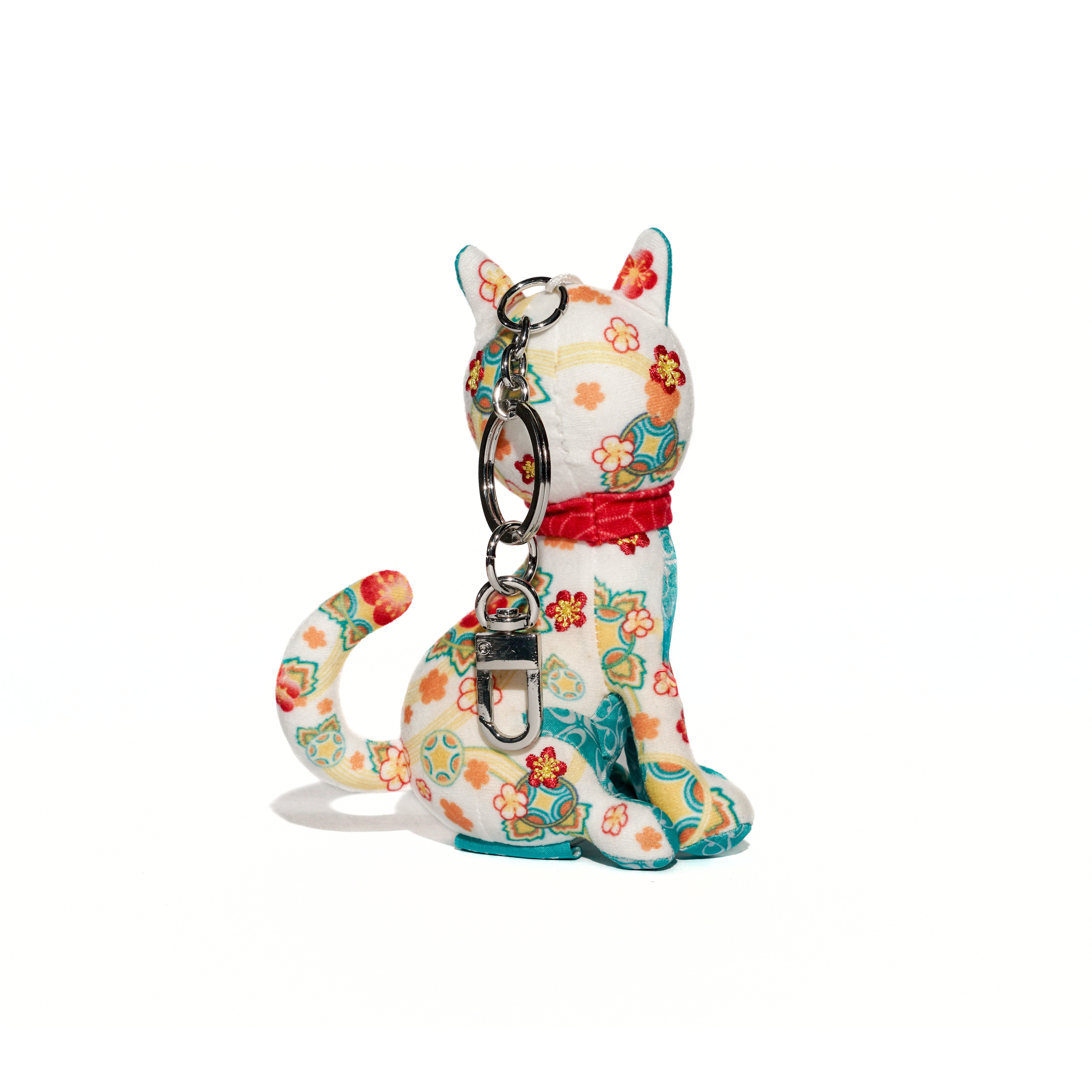 Colorful cat-shaped keychain with floral patterns on a white background