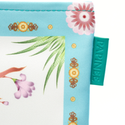 Close-up of a decorative product with floral and leaf patterns on a blue background, featuring the brand 'Papinee'.