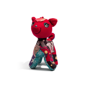 Red plush toy with a patterned outfit on a white background
