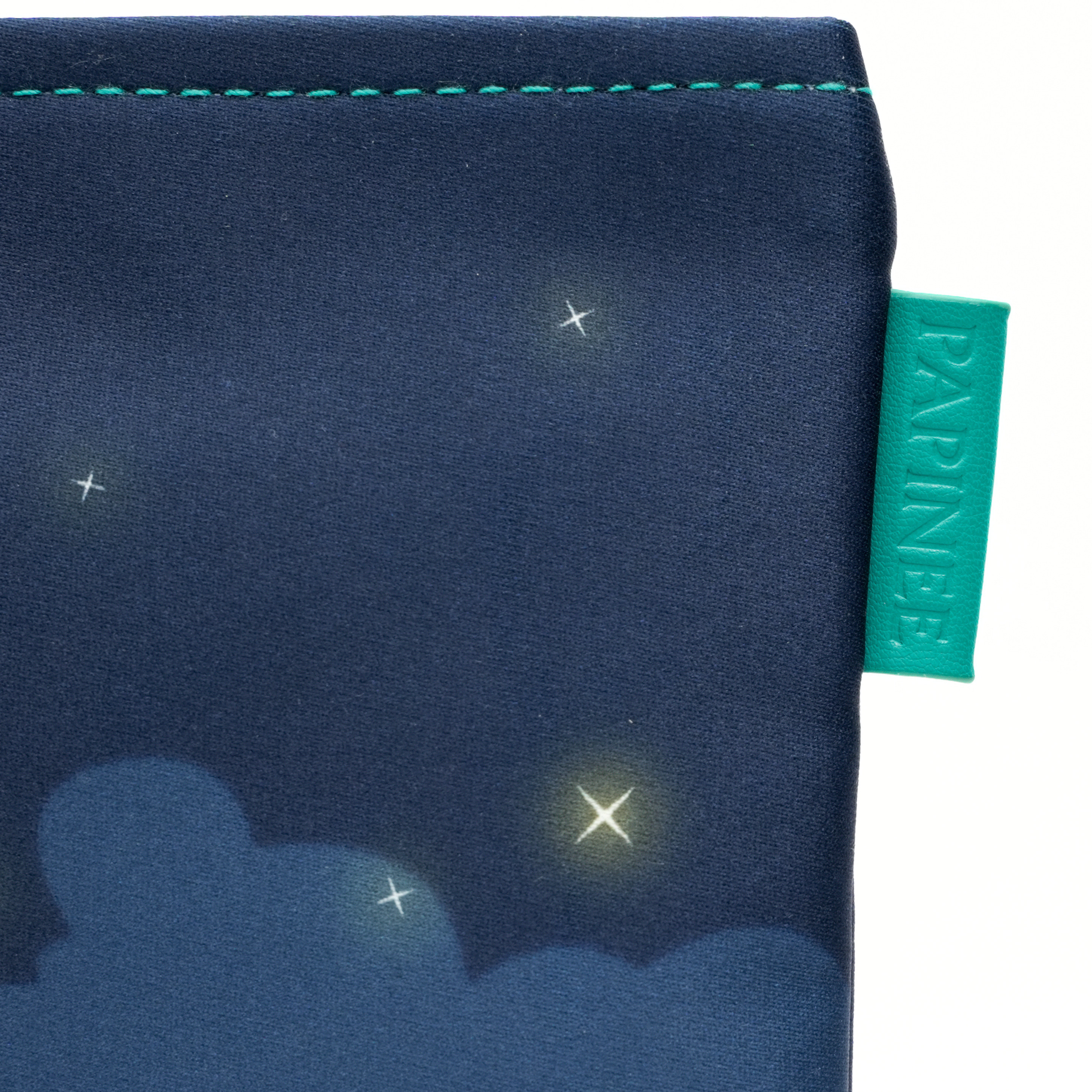 Navy blue fabric with star and cloud pattern and Papinelle label.