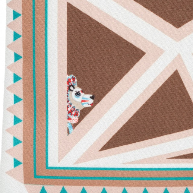 Patterned fabric with geometric design and a small animal illustration.