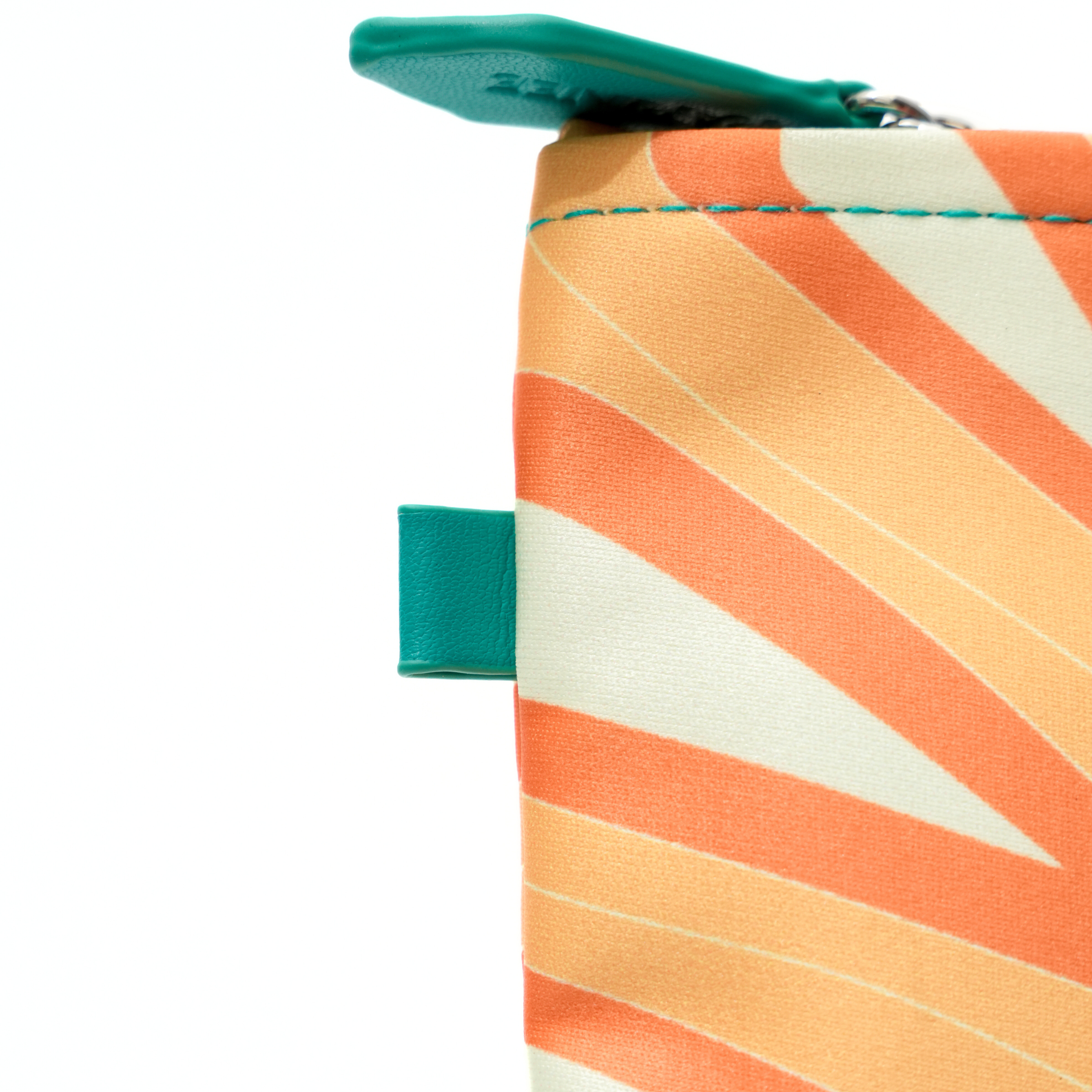 Close-up of a colorful striped pouch with green zippers on a white background