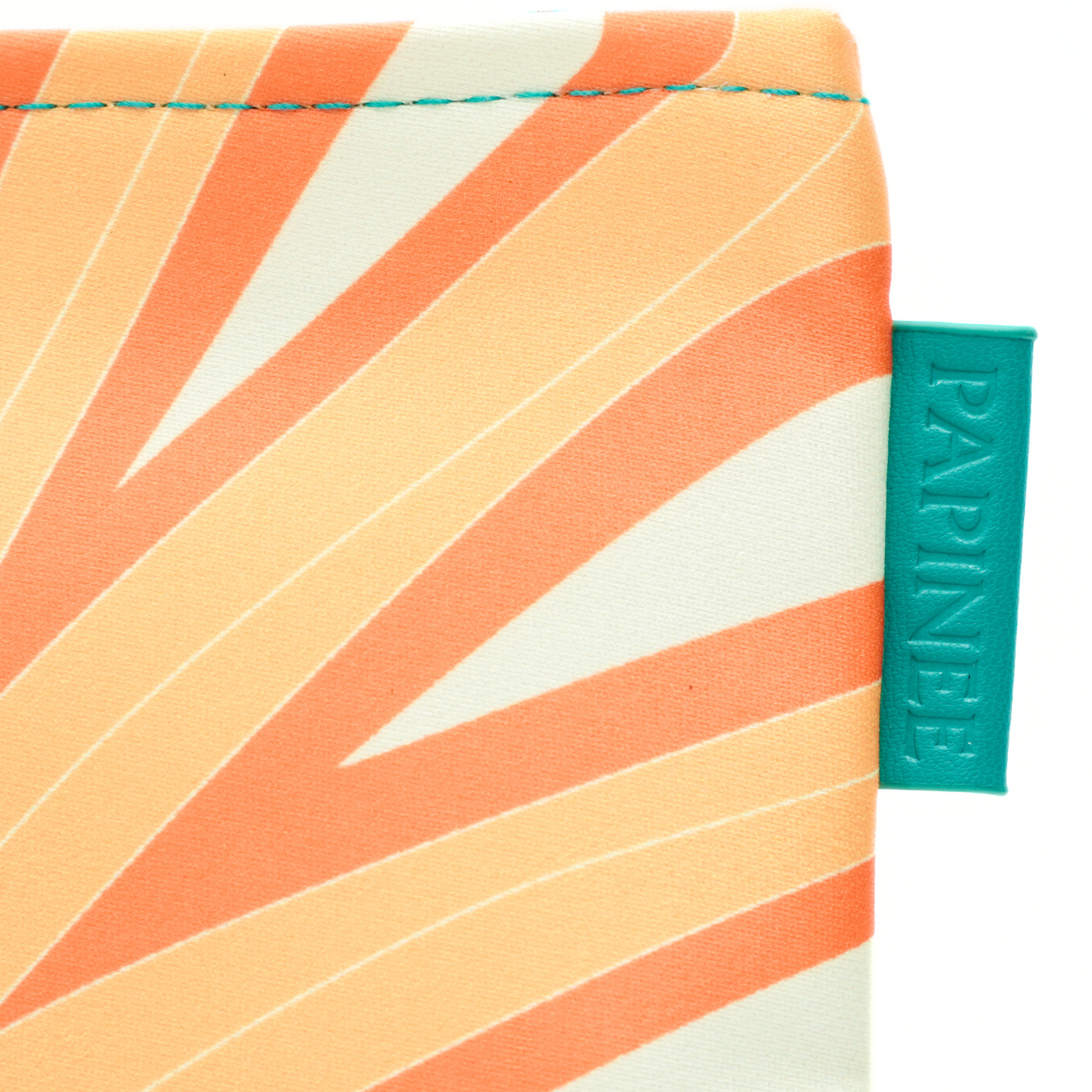 Close-up of a product with a colorful striped pattern and a visible brand tag on a white background.