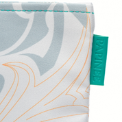 Fabric with leaf pattern and a green tag on a white background