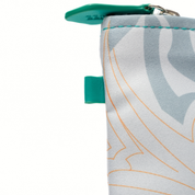 Close-up of a fabric pouch with a geometric pattern and teal accents on a white background