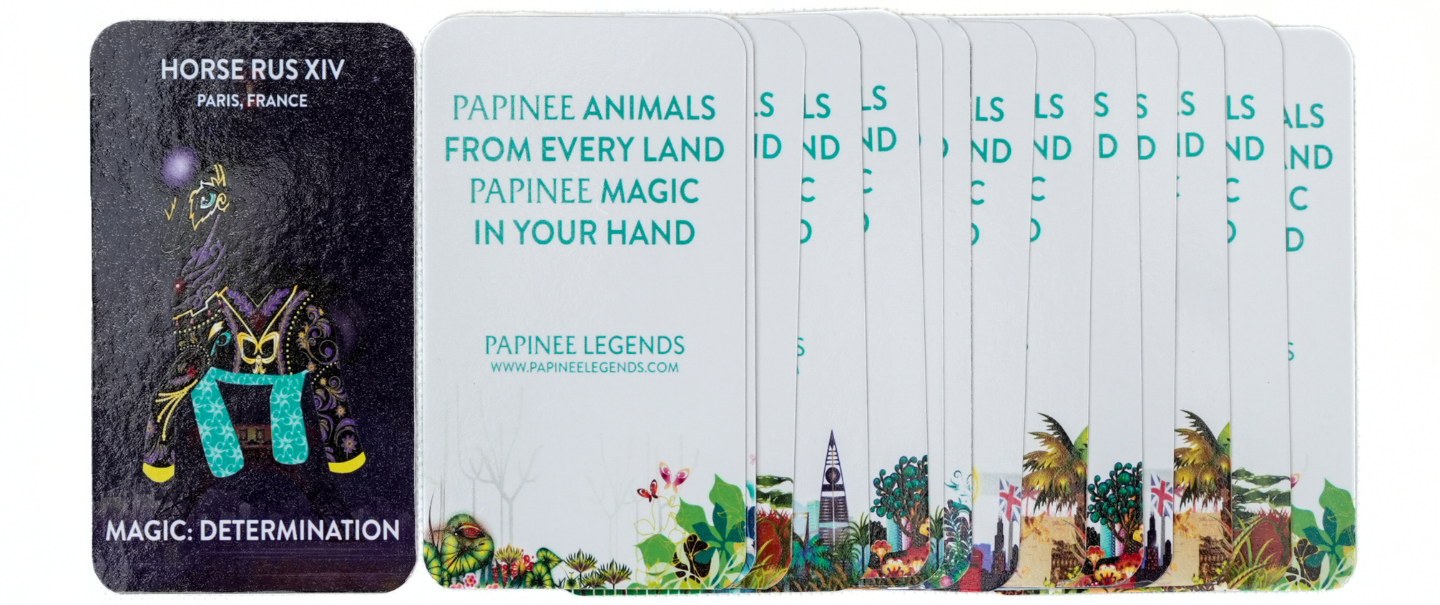 Collection of trading cards with a dark card featuring a creature and a light card with illustrations and text.