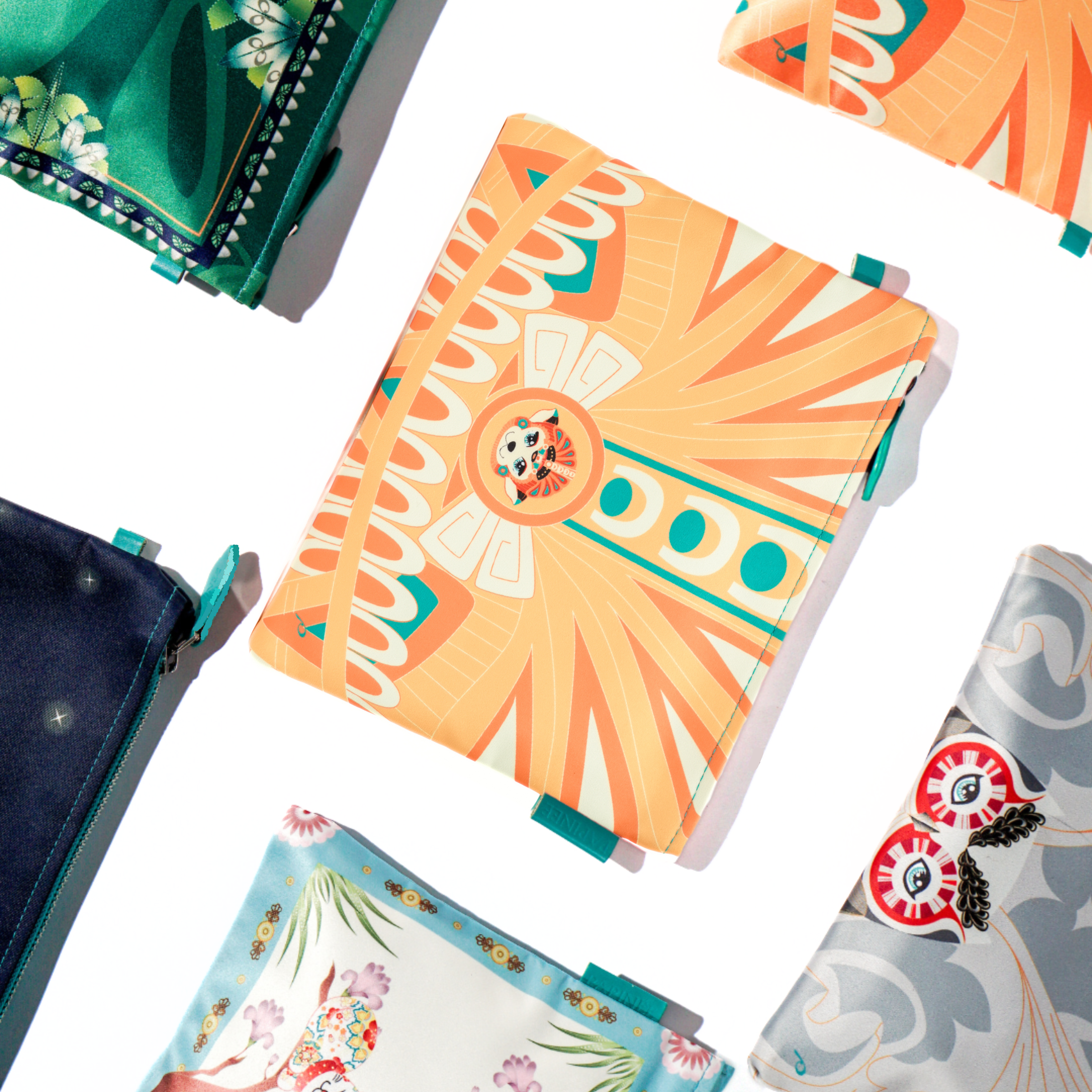 Collection of pouch with floral and abstract designs on a white background