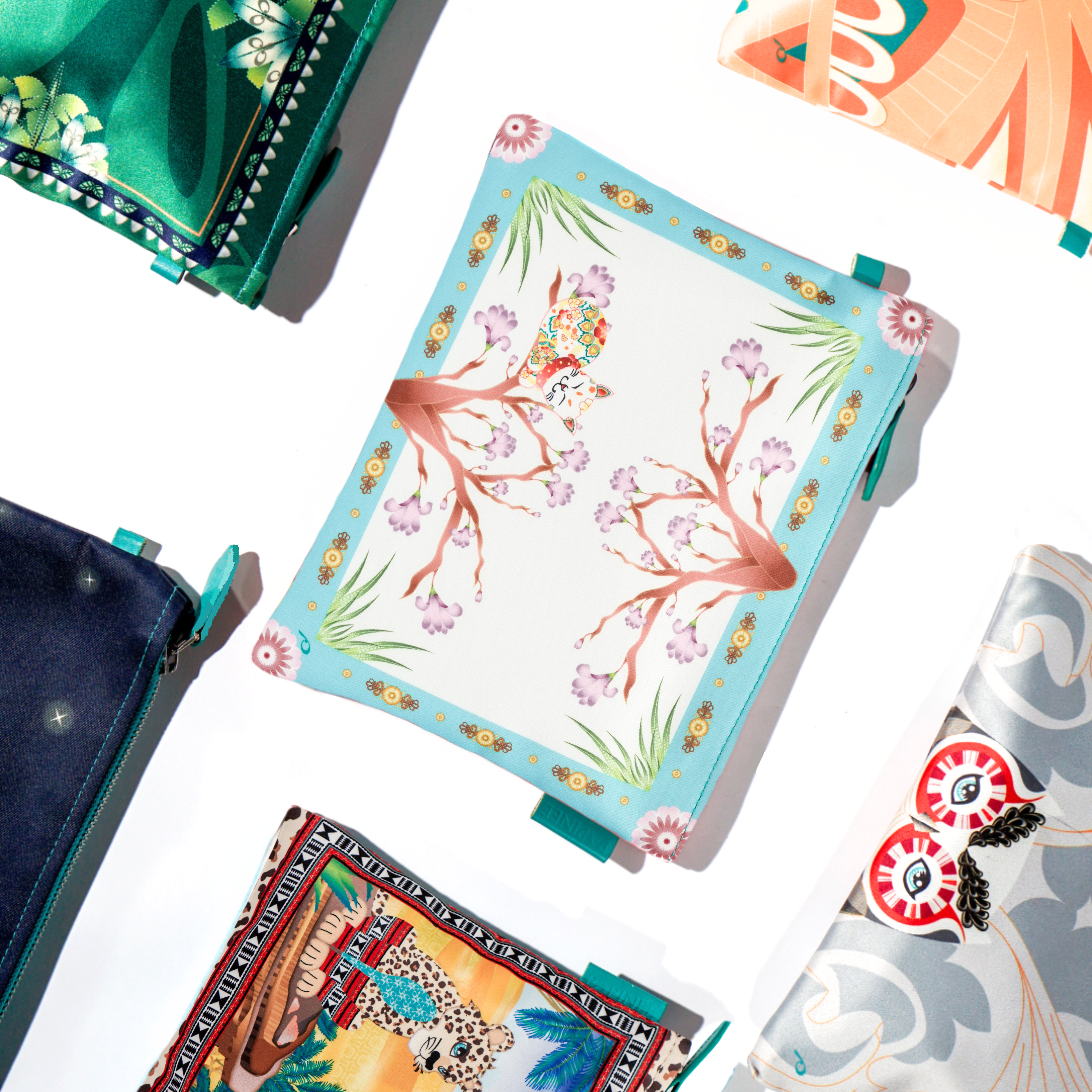 Collection of pouch with floral and abstract designs on a white background