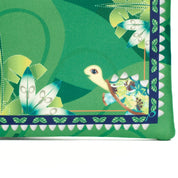 Green fabric with a turtle design and leaf patterns